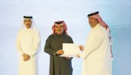 Minister of Finance H E Ali bin Ahmed Al Kuwari presenting a certificate of appreciation to Director of the Wildlife Development Department Mohamed Ahmed Al Khanji.
