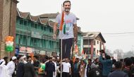 Indian Congress leader Rahul Gandhi (left) along with sister Priyanka Gandhi hoists the Indian national flag during the 'Bharat Jodo Yatra' march in Srinagar on January 29, 2023. (Photo by TAUSEEF MUSTAFA / AFP)