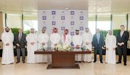 Qatari Diar Real Estate Investment Co. and the Qatar Financial Centre Authority (QFCA) officials pose for a photograph after the signing ceremony.