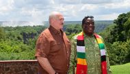 Belarus' President Alexander Lukashenko and Zimbabwean President Emmerson Mnangagwa visit the Victoria Falls on the Zambezi River, on the border with Zambia, on February 1, 2023. (Photo by Andrei STASEVICH / BELTA / AFP) / Belarus OUT