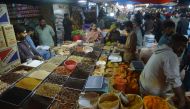 People buy spices at a wholesale market in Karachi on February 1, 2023. (Photo by Rizwan Tabassum / AFP)