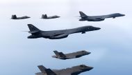 This handout photo taken on February 1, 2023 and provided by the South Korean Defence Ministry in Seoul shows two US Air Force B-1B strategic bombers (centre), South Korean Air Force F-35 fighter jets (bottom) and US Air Force F-22 stealth fighter jets flying over the Yellow Sea, located between China and the Korean peninsula, during a joint air drill. (South Korean Defence Ministry via AFP)
