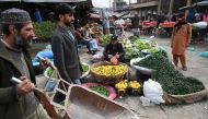 People buy vegetable at a market in Islamabad on February 3, 2023. - Pakistan's Prime Minister Shehbaz Sharif said February 3 the government would have to agree to IMF bailout conditions that are 