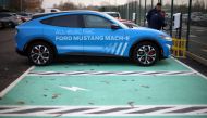 FILE PHOTO: Workers plug in an electric Ford Mustang Mach-e electric vehicle during a press event at the Ford Halewood transmissions plant in Liverpool, Britain, December 1, 2022. REUTERS/Phil Noble