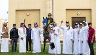 The connection of Midrass celebrate after the Ghazwan Racing’s seven-year-old horse won the Mesaieed Cup at Al Uqda Equestrian Complex, yesterday. PICTURES: JUHAIM/QREC