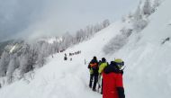 A photo taken on February 4, 2023 shows rescuers during their mission on a slope near Pill, western Austria. - Avalanches in Austria and Switzerland have left five people dead, leading officials to warn on February 4 of the risks posed by particularly unstable snow cover. Three of those killed were visiting Austria's Alpine regions. (Photo by ZOOM.TIROL / APA / AFP) 