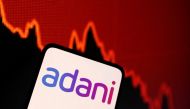 Adani logo and decreasing stock graph is seen in this illustration taken on January 31, 2023. REUTERS/Dado Ruvic/Illustration/File Photo