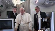 Pope Francis arrives to address the media while aboard the plane from Juba to Rome on February 5, 2023 returning from he Pope's visit to Democratic Republic of Congo and South Sudan. (Photo by Tiziana FABI / POOL / AFP)