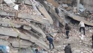 Rescue workers and volunteers conduct search and rescue operations in the rubble of a collasped building, in Diyarbakir on February 6, 2023, after a 7.8-magnitude earthquake struck the country's south-east. (Photo by ILYAS AKENGIN / AFP)