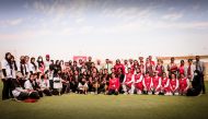 Players and officials of Pakistan International School and Birla Public School pose for a photograph with the officials of the Qatar Cricket Association after the final.
