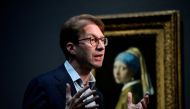 General Director of the Rijksmuseum Taco Dibbits speaks to journalists as he stands in front of a painting by the Dutch master Johannes Vermeer titled, 'Girl with a pearl earing' at the Rijksmuseum in Amsterdam on February 6, 2023. Photo by JOHN THYS / AFP