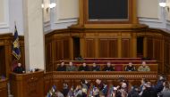 Ukraine's acting Minister of Internal Affairs Ihor Klymenko (2R/REAR) and acting Head of Security Service of Ukraine Vasyl Maliuk (R/REAR), attend a session of the Ukrainian Parliament with Ukraine's President Volodymyr Zelensky (L) where deputies will vote on the appointment in Kyiv on February 7, 2023, amid the Russian invasion of Ukraine. (Photo by ANDRII NESTERENKO / AFP)