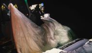 This picture provided by the US Navy shows sailors assigned to Explosive Ordnance Disposal Group 2 recover a high-altitude surveillance balloon off the coast of Myrtle Beach, South Carolina, in the Atlantic ocean on February 5, 2023.