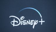 In this file photo taken on November 13, 2019 the Disney+ logo is seen on the backdrop for the World Premiere of 