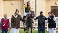 The connection of Ghannam celebrate after the Abdullah Saeed Abdullah Al Mesnad-owned seven-year-old horse won the Al Arish Cup at Al Uqda Racecourse yesterday. PICS: JUHAIM/QREC