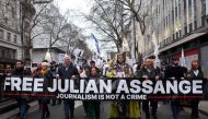 Supporters of WikiLeaks founder Julian Assange take part in a 'Night Carnival for Assange' march in London on February 11, 2023. (Photo by Susannah Ireland / AFP)