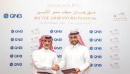 QREC Chairman Issa bin Mohammed Al Mohannadi and QNB Vice President External Communications Yousef Fakhroo shake hands after renewing the partnership.  