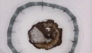 This aerial view from February 7, 2023 shows the collapsed ground surrounded by a metal barrier at the local football pitch in Trzebinia, Poland. Photo by Wojtek RADWANSKI / AFP