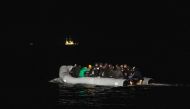 (FILES) In this file photo taken on March 15, 2022 migrants sits in a dinghy illegally crossing the English Channel from France to Britain. (Photo by Sameer Al-DOUMY / AFP)
