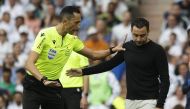 Real Madrid v FC Barcelona - Santiago Bernabeu, Madrid, Spain - October 16, 2022 Referee Jose Maria Sanchez Martinez talks to FC Barcelona coach Xavi REUTERS/Susana Vera
