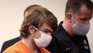 (FILES) In this file photo taken on May 19, 2022, Payton Gendron arrives for a hearing at the Erie County Courthouse in Buffalo, New York. - A man in court on February 15, 2023, lunged at the Gendron, 19, who murdered 10 Black people during a live-streamed supermarket rampage in Buffalo, New York, on May 14, 2022, disrupting the sentencing hearing for the self-declared white supremacist. (Photo by SCOTT OLSON / GETTY IMAGES NORTH AMERICA / AFP)