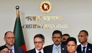 US State Department Counselor Derek Chollet (C) speaks as Bangladesh's Foreign Minister AK Abdul Momen (2R) watches during a joint press conference in Dhaka. (Photo by Munir uz zaman / AFP)