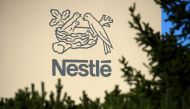 A logo of the world's leading food industry group Nestle is seen on October 9, 2014 at the group's Research Center in Vers-chez-les-Blanc above Lausanne. (Photo by Fabrice Coffrini / AFP)