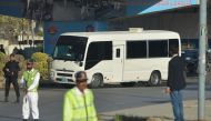 Security personnel cordon off a street as a bus carrying cricketers of 'Karachi Kings' and 'Quetta Gladiators' arrive for Pakistan Super League (PSL) T20 cricket match at the National Stadium in Karachi on February 18, 2023. (Photo by Rizwan TABASSUM / AFP)