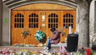 EAST LANSING, MI - FEBRUARY 20: A woman sits at Berkey Hall while Michigan State University students return to classes for the first time since the February 13 mass shooting there on February 20, 2023 in East Lansing, Michigan. The gunman shot 8 students on the campus of MSU, killing 3 of them, one of them at Berkey Hall.. Approximately 50,000 students are enrolled at Michigan State. Bill Pugliano/Getty Images/AFP (Photo by BILL PUGLIANO / GETTY IMAGES NORTH AMERICA / Getty Images via AFP)