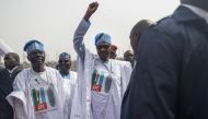 President of Nigeria Muhammadu Buhari (2nd R) raises his fist as he arrives at the All Progressives Congress (APC campaign rally at Teslim Balogun Stadium in Lagos on February 21, 2023 ahead of the Nigerian presidential election scheduled for February 25, 2023. (Photo by Michele Spatari / AFP)