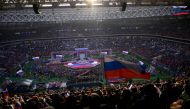 People listen as President Vladimir Putin (center on the stage) gives a speech during a patriotic concert dedicated to the upcoming Defender of the Fatherland Day at the Luzhniki stadium in Moscow on February 22, 2023. (Photo by Natalia KOLESNIKOVA / AFP)