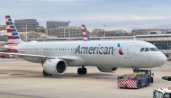 An American Airlines plane sits at the gate at Ronald Reagan Washington National Airport (DCA) in Arlington, Virginia on february 23, 2023. (Photo by Daniel SLIM / AFP)