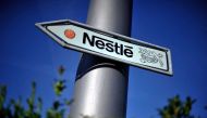 This file photo taken on August 10, 2011 shows Nestle's logo on a road sign near the company's headquarters in Vevey, Switzerland. (Photo by Fabrice Coffrini / AFP)