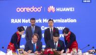 Ooredoo and Huawei officials signing Network Modernisation agreement at Mobile World Congress at the Fira Gran Via, Barcelona.
