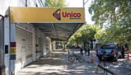 Police inspect a supermarket belonging to the family of Antonela Roccuzzo, the wife of Argentine football star Lionel Messi, after attackers fired shots at the facade of the closed premises early in the morning and left a threat message to Messi, in Rosario, Santa Fe Province, Argentina, on March 2, 2023. - Two men attacked the front of a supermarket belonging to the in-laws of Messi and left a written message mentioning the captain of the world champion Argentine team, the mayor of the city Pablo Javkin said. 