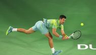 Serbia's Novak Djokovic hits a return against Russia's Daniil Medvedev (not pictured) during their ATP Dubai Duty Free Tennis Championship semi-final match in Dubai, on March 3, 2023. (Photo by Karim Sahib / AFP)