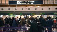 In this file photo taken on February 1, 2021, travellers queue at the immigration desk of Roissy Charles-de-Gaulle international airport in Paris, France.  (Photo by Christophe Archambault / AFP)


