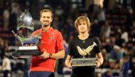 Russia's Daniil Medvedev (left) and Andrey Rublev pose with their trophies after the former won the ATP Dubai Duty Free Tennis Championship final match in Dubai, on March 4, 2023. (Photo by Karim SAHIB / AFP)
