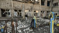 A man walks outside a destroyed school after a missile strike in Kramatorsk, Dombass regions, on March 6, 2023, amid Russian invasion of Ukraine. (Photo by Aris Messinis / AFP)
 