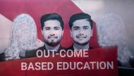 A banner seen with images of women defaced using spray paint are pictured inside a private university after the universities were reopened in Kabul on March 6, 2023. - Male students trickled back to their classes on March 6 after Afghan universities reopened following a winter break but women remain barred by Taliban authorities. (Photo by Wakil KOHSAR / AFP)