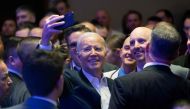 US President Joe Biden takes a selfie with attendees after speaking at the 2023 International Association of Fire Fighters Legislative Conference in Washington, DC, on March 6, 2023. (Photo by SAUL LOEB / AFP)