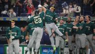Australia's Timothy Kennelly (centre L) celebrates with teammates after hitting a home run during the World Baseball Classic (WBC) Pool B round game between Australia and South Korea at the Tokyo Dome in Tokyo on March 9, 2023. (Photo by Richard A. Brooks / AFP)
