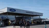 Workers leave the Ford factory in Almussafes near Valencia, on March 10, 2023, after the US carmaker announced it will cut around 1,100 jobs at this factory as it reorganises its operations in Europe. (Photo by JOSE JORDAN / AFP)