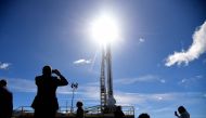 Jounalists gather next to the Spanish aerospace company PLD Space's 'Miura-1' suborbital rocket, the first European private rocket to be launched into space, in Almonte's launch pad, near Huelva, southern Spain, on March 11, 2023. - 'Miura-1' micro rocket is aimed at sending small satellites to space. (Photo by CRISTINA QUICLER / AFP)