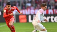 Bayern Munich's Portuguese midfielder Joao Cancelo (L) and Augsburg's Danish defender Mads Pedersen vie for the ball during the German first division Bundesliga football match between Bayern Munich and Augsburg in Munich on March 11, 2023. (Photo by Christof STACHE / AFP) 