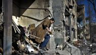 A local resident looks for his belongings after a shelling in Kramatorsk, eastern Ukraine, on March 14, 2023, amid the Russian invasion of Ukraine. Photo by Sergey SHESTAK / AFP