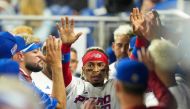 MIAMI, FLORIDA - MARCH 13: Francisco Lindor #12 of Puerto Rico is congratulated by teammates after scoring on a double hit by Enrique Hernandez #5 in the second inning against Israel at loanDepot park on March 13, 2023 in Miami, Florida. Eric Espada/Getty Images/AFP (Photo by Eric Espada / GETTY IMAGES NORTH AMERICA / Getty Images via AFP)