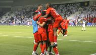 Al Duhail players celebrate after Federico Fernandez scored their second goal against Al Sadd.