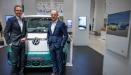 Oliver Blume (left), CEO of German car giant Volkswagen (VW), and VW CFO & COO Arno Antlitz stand in front of a Volkswagen ID Buzz van on the sidelines of their company's annual press conference to present the business report, on March 14, 2023 in Berlin.  (Photo by Odd ANDERSEN / AFP)