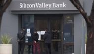 Employees stand outside the headquarters of Silicon Valley Bank in Santa Clara, California, after it was closed.  File photo / AFP
